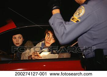 Stock Photography - police officer 
stopping couple 
in red car, examining 
license. fotosearch 
- search stock 
photos, pictures, 
images, and photo 
clipart