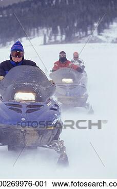 Stock Photography - three people riding 
snowmobiles. fotosearch 
- search stock 
photos, pictures, 
images, and photo 
clipart