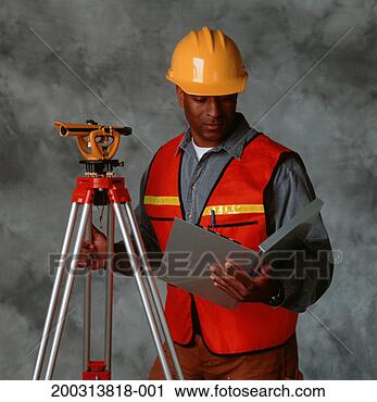 Stock Photography - building surveyor 
wearing helmet, 
 with theodolite 
and laptop. fotosearch 
- search stock 
photos, pictures, 
images, and photo 
clipart