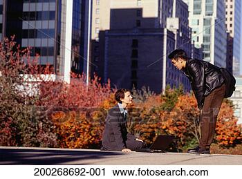 Stock Photography - businesswoman 
sitting outside 
in city using 
laptop, talking 
to man. fotosearch 
- search stock 
photos, pictures, 
images, and photo 
clipart