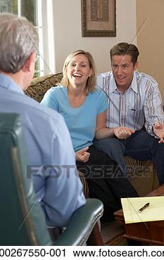 Stock Photography - couple laughing 
and talking to 
counselor at home. 
fotosearch - search 
stock photos, 
pictures, images, 
and photo clipart