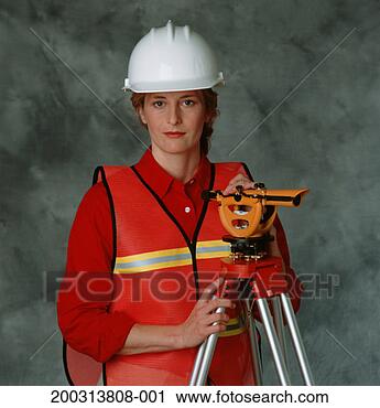 Stock Photography - female building 
surveyor in hard 
hat,  with theodolite, 
 in studio. fotosearch 
- search stock 
photos, pictures, 
images, and photo 
clipart