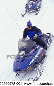 Stock Photography - person riding 
snowmobile, elevated 
view. fotosearch 
- search stock 
photos, pictures, 
images, and photo 
clipart