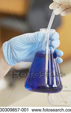 Stock Photography - person wearing 
gloves holding 
a dropper in a 
flask. fotosearch 
- search stock 
photos, pictures, 
images, and photo 
clipart
