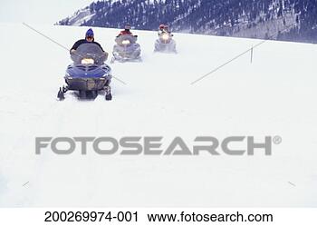 Stock Photography - three people riding 
snowmobiles. fotosearch 
- search stock 
photos, pictures, 
images, and photo 
clipart