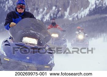 Stock Photography - three people riding 
snowmobiles. fotosearch 
- search stock 
photos, pictures, 
images, and photo 
clipart