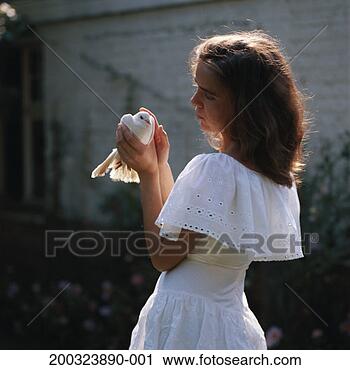 Stock Photography - young woman patting 
dove, side view. 
fotosearch - search 
stock photos, 
pictures, images, 
and photo clipart