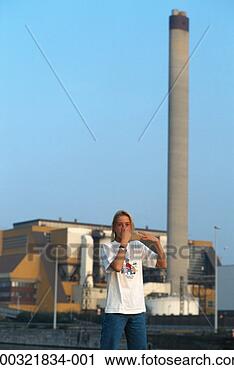 Stock Photography - teenage girl (16-17) 
standing outdoors, 
plugging nose. 
fotosearch - search 
stock photos, 
pictures, images, 
and photo clipart