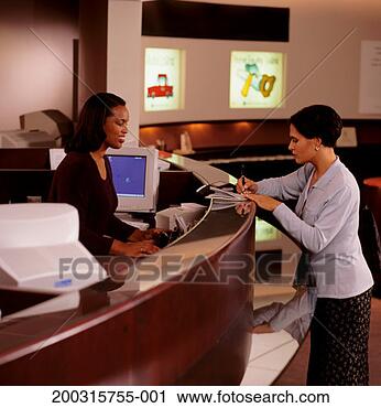 Stock Photography - woman signing 
documents at bank 
counter. fotosearch 
- search stock 
photos, pictures, 
images, and photo 
clipart