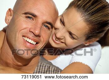 Stock Photography - young couple embracing, 
close-up. fotosearch 
- search stock 
photos, pictures, 
images, and photo 
clipart