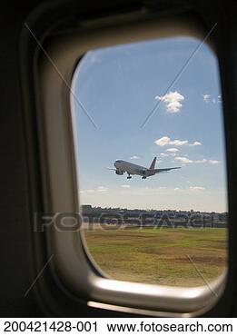Stock Photography - airplane landing, 
view through airplane 
window. fotosearch 
- search stock 
photos, pictures, 
images, and photo 
clipart