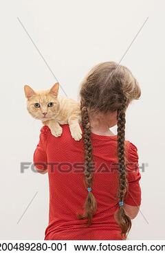 Stock Photography - girl (9-11) holding 
cat, cat looking 
over shoulder. 
fotosearch - search 
stock photos, 
pictures, images, 
and photo clipart