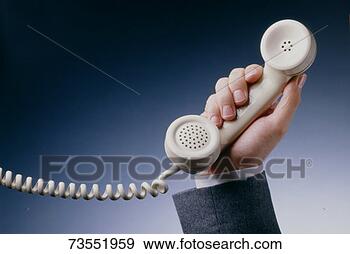 Stock Photograph - man holding telephone, 
close up of receiver 
hand. fotosearch 
- search stock 
photos, pictures, 
images, and photo 
clipart
