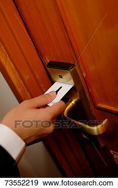 Stock Photograph - man using key 
card in door lock. 
fotosearch - search 
stock photos, 
pictures, images, 
and photo clipart