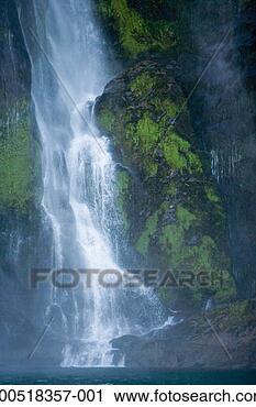 Stock Photography - new zealand, south 
island, waterfall 
flowing into milford 
sound, dawn. fotosearch 
- search stock 
photos, pictures, 
images, and photo 
clipart
