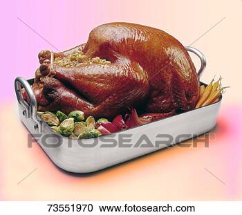 Stock Photography - roasted stuffed 
turkey with vegetables 
on tray,  colored 
background. fotosearch 
- search stock 
photos, pictures, 
images, and photo 
clipart