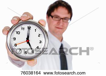 Stock Photo - businessman holding 
clock with clock 
at 5pm position, 
 focus on. fotosearch 
- search stock 
photos, pictures, 
images, and photo 
clipart