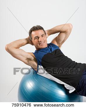Stock Photo - senior man exercising 
on fitness ball, 
portrait, smiling. 
fotosearch - search 
stock photos, 
pictures, images, 
and photo clipart