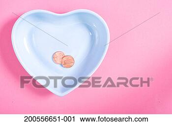 Stock Photography - two pennies in 
heart-shaped dish 
on pink background, 
overhead view. 
fotosearch - search 
stock photos, 
pictures, images, 
and photo clipart