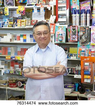 Stock Photo - shop owner smiling, 
behind shop counter, 
portrait. fotosearch 
- search stock 
photos, pictures, 
images, and photo 
clipart