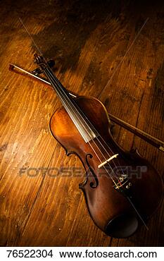 Stock Photo - violin on old 
wooden background. 
fotosearch - search 
stock photos, 
pictures, images, 
and photo clipart