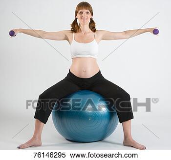 Stock Image - woman using dumbbells, 
sitting on exercise 
ball, portrait. 
fotosearch - search 
stock photos, 
pictures, images, 
and photo clipart