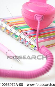 Stock Photography - close up of pink 
telephone receiver 
on top of phone 
book with pen. 
fotosearch - search 
stock photos, 
pictures, images, 
and photo clipart