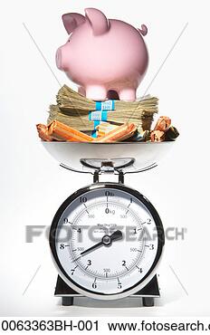 Stock Photography - weight scale with 
stacks of us notes, 
 rolls of change 
and piggy bank. 
fotosearch - search 
stock photos, 
pictures, images, 
and photo clipart