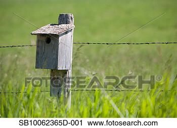 Stock Photography - wooden birdhouse 
in fields by farmland 
barbed wire. fotosearch 
- search stock 
photos, pictures, 
images, and photo 
clipart