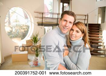 Stock Photography - couple wearing 
matching polo 
necks, embracing, 
smiling, portrait. 
fotosearch - search 
stock photos, 
pictures, images, 
and photo clipart