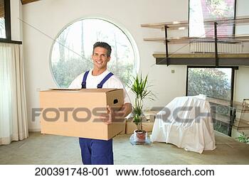 Stock Photography - removal man carrying 
large cardboard 
box, smiling, 
portrait. fotosearch 
- search stock 
photos, pictures, 
images, and photo 
clipart