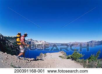 Stock Photography - usa, oregon, crater 
lake  national 
park, hiker by 
crater lake. fotosearch 
- search stock 
photos, pictures, 
images, and photo 
clipart