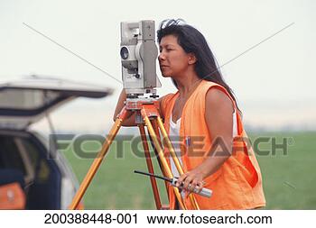 Stock Photography - woman using surveyor 
using surveyor 
tool. fotosearch 
- search stock 
photos, pictures, 
images, and photo 
clipart