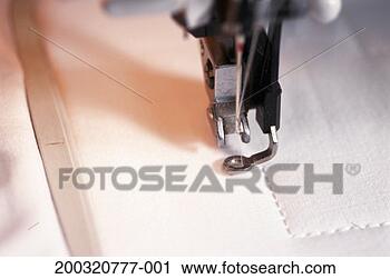 Stock Photography - close-up of sewing 
machine needle 
stitching cloth. 
fotosearch - search 
stock photos, 
pictures, images, 
and photo clipart
