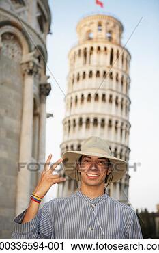 Stock Photography - italy, tuscany, 
young man standing 
in front of leaning 
tower of pisa. 
fotosearch - search 
stock photos, 
pictures, images, 
and photo clipart
