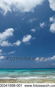 Stock Photography - japan, okinawa, 
miyako island, 
wave breaking 
under blue sky. 
fotosearch - search 
stock photos, 
pictures, images, 
and photo clipart
