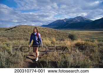Stock Photography - usa, colorado, 
aspen, crested 
butte, young woman 
hiking on trail. 
fotosearch - search 
stock photos, 
pictures, images, 
and photo clipart