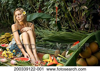 Stock Photography - woman on mat outdoors, 
surrounded in 
tropical fruit. 
fotosearch - search 
stock photos, 
pictures, images, 
and photo clipart