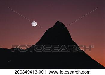 Stock Photography - moonrise over 
mitre peak, dusk 
(multiple exposure). 
fotosearch - search 
stock photos, 
pictures, images, 
and photo clipart
