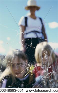 Stock Photography - mother with two 
children (9-12) 
looking at spider 
(focus on spider). 
fotosearch - search 
stock photos, 
pictures, images, 
and photo clipart