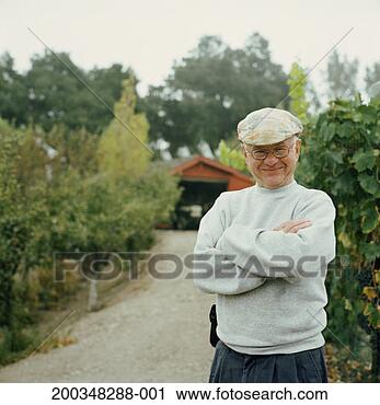 Stock Photography - senior man smiling, 
arms crossed, 
in front of shed, 
portrait. fotosearch 
- search stock 
photos, pictures, 
images, and photo 
clipart