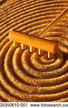 Stock Photography - tool sculpting 
concentric circles 
in zen sand garden, 
close-up. fotosearch 
- search stock 
photos, pictures, 
images, and photo 
clipart