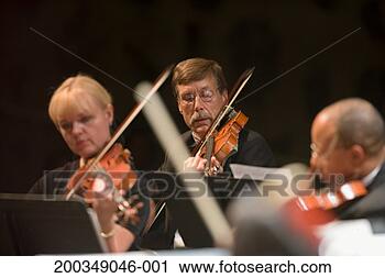 Stock Photography - violinists in 
orchestra during 
performance. fotosearch 
- search stock 
photos, pictures, 
images, and photo 
clipart