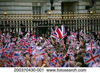 Stock Photography - crowd waving union 
jack flags outside 
buckingham palace 
iron railings. 
fotosearch - search 
stock photos, 
pictures, images, 
and photo clipart