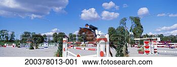Stock Photography - horse and rider 
competing in show 
jumping event 
(blurred motion). 
fotosearch - search 
stock photos, 
pictures, images, 
and photo clipart