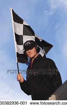 Stock Photography - male race official 
holding checkered 
flag, portrait, 
low angle view. 
fotosearch - search 
stock photos, 
pictures, images, 
and photo clipart