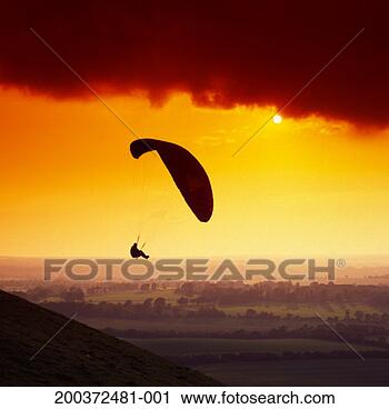 Stock Photography - silhouette of 
paraglider above 
countryside, sunset. 
fotosearch - search 
stock photos, 
pictures, images, 
and photo clipart