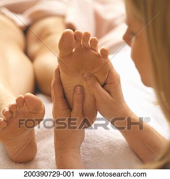 Stock Photography - woman getting 
foot massage from 
reflexologist 
(focus on foot). 
fotosearch - search 
stock photos, 
pictures, images, 
and photo clipart
