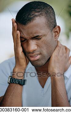 Stock Photography - young man rubbing 
temple and neck, 
eyes closed. fotosearch 
- search stock 
photos, pictures, 
images, and photo 
clipart