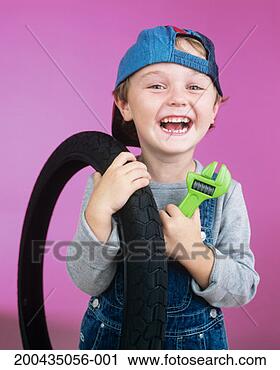 Stock Photography - boy (2-4) holding 
tyre and toy spanner, 
smiling, portrait. 
fotosearch - search 
stock photos, 
pictures, images, 
and photo clipart